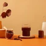 black coffee with plant, coffee beans and milk, source: Shutterstock