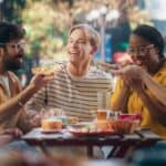 Multiethnic group of people eating outside, source: Shutterstock