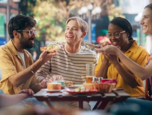 Multiethnic group of people eating outside, source: Shutterstock